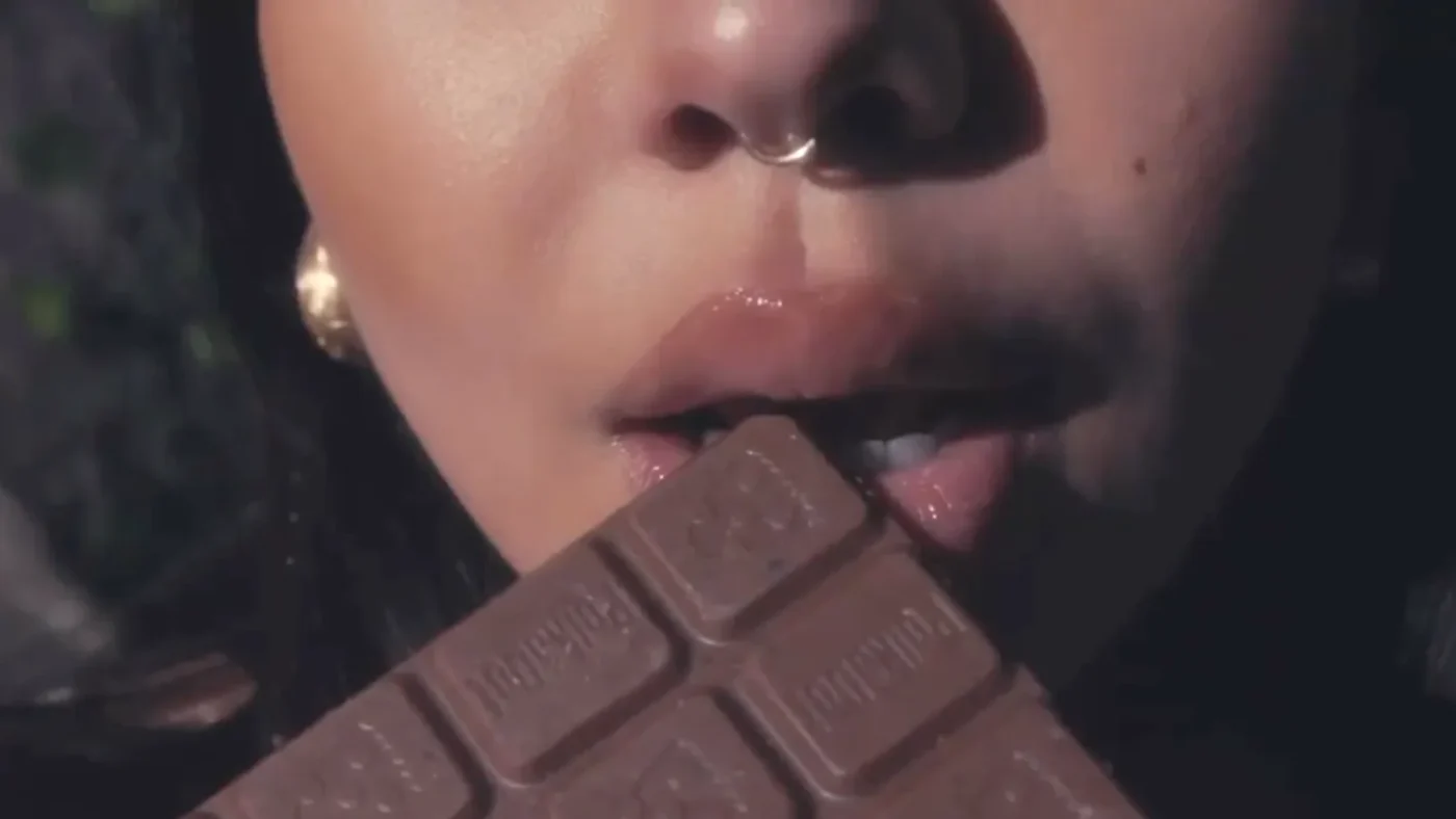 A woman about to joyfully savor a Polkadot Mushroom Chocolate Bar